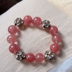 Boutique bracelet, peach/pink color. Never worn. No missing stones.